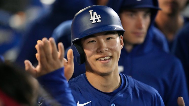 Los Angeles Dodgers' Hyeseong Kim, of South Korea, smiles as he celebrates after scoring against the Seattle Mariners during the third inning of a spring training baseball game Friday, March 7, 2025, in Peoria, Ariz. (Ross D. Franklin/AP)