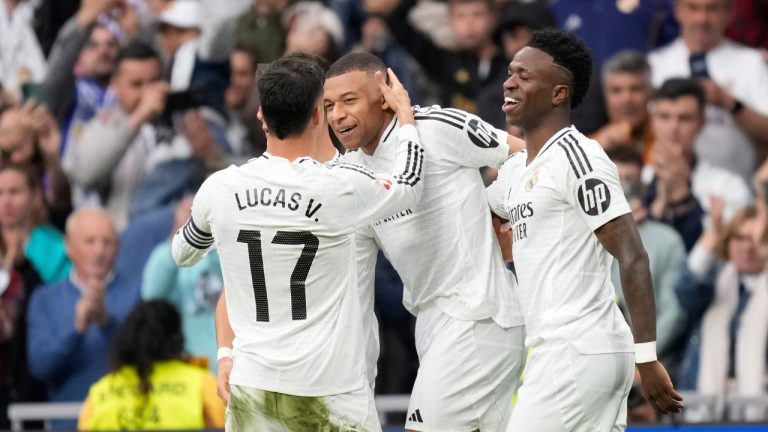 Real Madrid's Kylian Mbappe, centre, celebrates with teammates after scoring his side's third goal during the Spanish La Liga soccer match between Real Madrid and Celta Vigo at the Santiago Bernabeu stadium in Madrid, Spain, Sunday, May 4, 2025. (Jose Breton/AP)