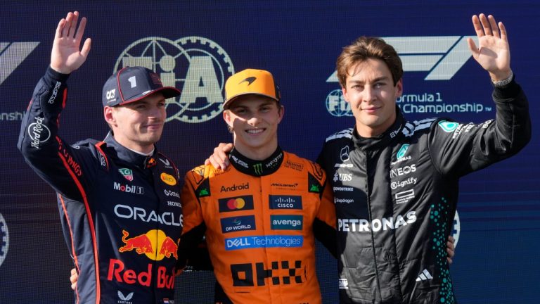 McLaren driver Oscar Piastri of Australia, centre, celebrates his pole position with second placed Red Bull driver Max Verstappen of the Netherlands, left, and Mercedes driver George Russell of Britain the qualifying session ahead of the Italy's Emilia Romagna Formula One Grand Prix, at the Enzo and Dino Ferrari racetrack in Imola, Italy, Saturday, May 17, 2025. (Luca Bruno/AP)