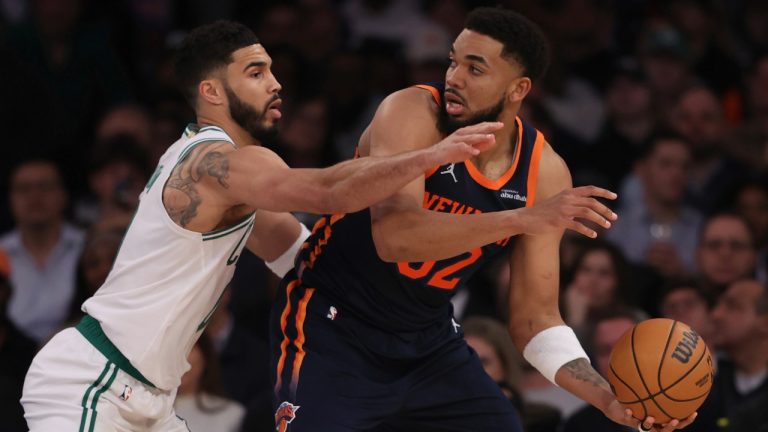 New York Knicks' Karl-Anthony Towns, right, looks to pass the ball past Boston Celtics' Jayson Tatum, left, during the second half of an NBA basketball game, Tuesday, April 8, 2025, in New York. (Pamela Smith/AP)