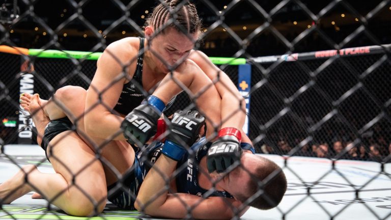 Erin Blanchfield, top, fights Rose Namajunas during a flyweight bout at a UFC Fight Night event. (Jason Franson/CP)