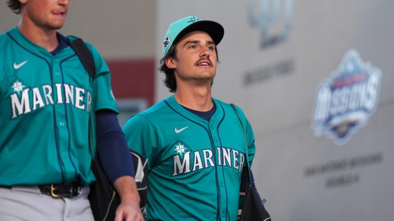 Seattle Mariners' Cole Young, right, arrives for a spring training baseball game against the San Diego Padres, Friday, Feb. 28, 2025, in Peoria, Ariz. (Lindsey Wasson/AP)