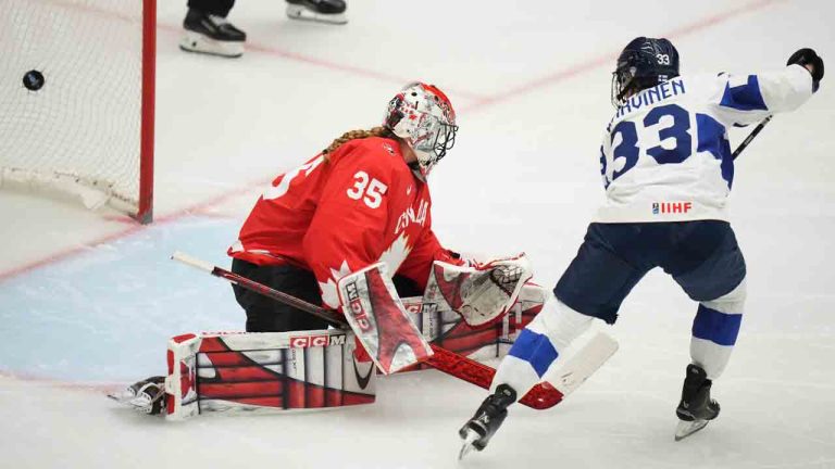 Finland's Michelle Karvinen, right, scores her sides first goal past Ann-Renee Desbiens of Canada during the semi final match between Canada and Finland at the Women's Ice Hockey Championships in Ceske Budejovice, Czech Republic, Saturday, April 19, 2025. (Petr David Josek/AP)