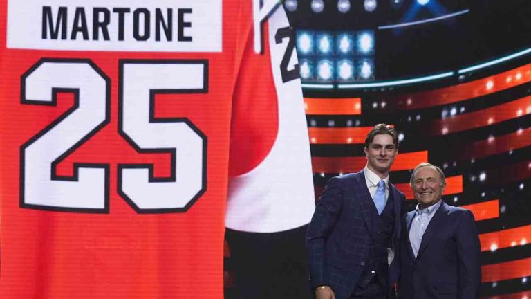 Porter Martone, second from right, stands next to NHL commissioner Gary Bettman after being drafted by the Philadelphia Flyers during the NHL hockey draft Friday, June 27, 2025, in Los Angeles. (Damian Dovarganes/AP)