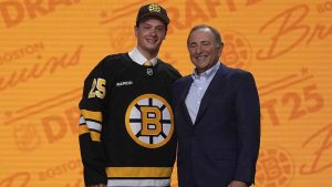 James Hagens, left, stands with NHL commissioner Gary Bettman after being drafted by the Boston Bruins during the NHL hockey draft Friday, June 27, 2025, in Los Angeles. (Damian Dovarganes/AP)