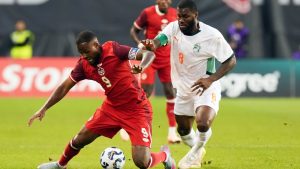 Canada's Cyle Larin, left, is knocked off the ball by Cote d'Ivoire's Franck Yannick Kessie during first half Canadian Shield Tournament action, in Toronto, on Tuesday June 10, 2025. (Chris Young/CP)