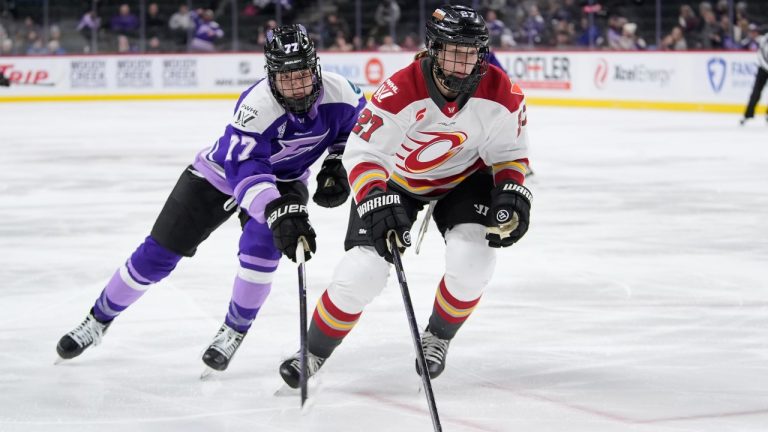 Ottawa Charge forward Shiann Darkangelo (27) skates with the puck as Minnesota Frost forward Britta Curl-Salemme (77) defends during the third period of a PWHL hockey game Tuesday, Jan. 21, 2025, in St. Paul, Minn. (Abbie Parr/AP)