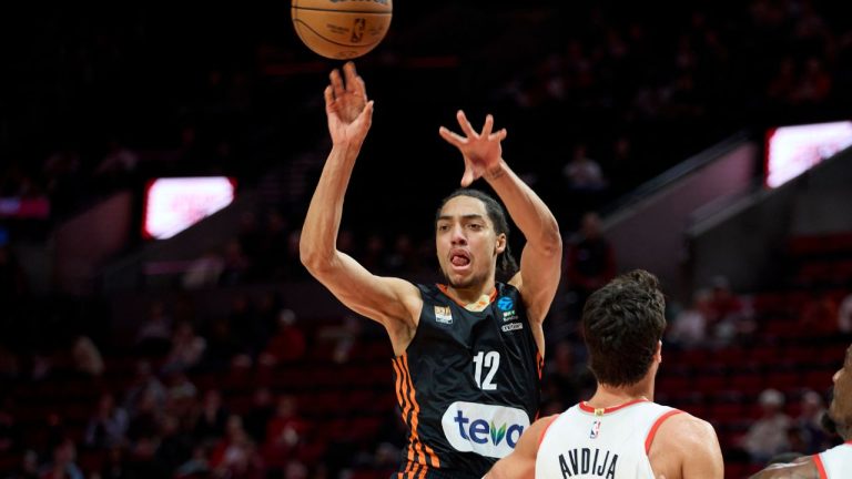 Ratiopharm Ulm forward Noa Essengue passes over Portland Trail Blazers forward Deni Avdija and centre Deandre Ayton during the first half of a pre-season NBA basketball game in Portland, Ore., Wednesday, Oct. 16, 2024. (Craig Mitchelldyer/AP)