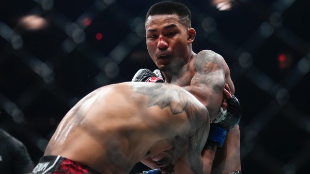 Joshua-Van-punches-an-opponent-during-a-flyweight-bout-at-a-UFC-event