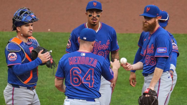 New York Mets pitcher Paul Blackburn (58) hands the ball to manager Carlos Mendoza (64) as he is removed from a baseball game during the second inning against the Pittsburgh Pirates in Pittsburgh, Saturday, June 28, 2025. (Gene J. Puskar/AP)
