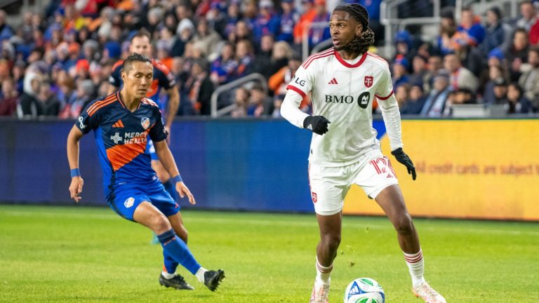 Toronto FC defender Zane Monlouis (12) looks for an open teammate during the first half of an MLS soccer match against FC Cincinnati, Saturday, March 8, 2025, in Cincinnati. (Tanner Pearson/AP)