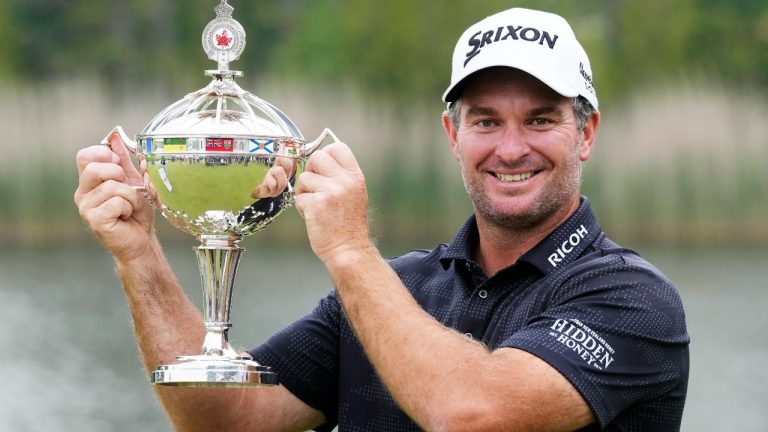 Ryan Fox poses with the championship trophy after winning the RBC Canadian Open golf tournament in Caledon, Ont., Sunday, June 8, 2025. (Frank Gunn/CP)