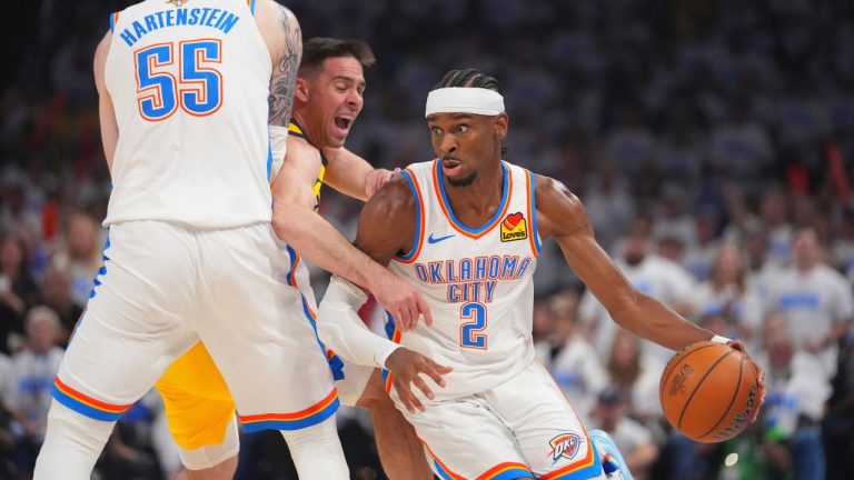 Oklahoma City Thunder guard Shai Gilgeous-Alexander controls the ball against Indiana Pacers guard T.J. McConnell, as Oklahoma City Thunder centre Isaiah Hartenstein defends during the first half of Game 1 of the NBA Finals basketball series Thursday, June 5, 2025, in Oklahoma City. (Julio Cortez/AP)