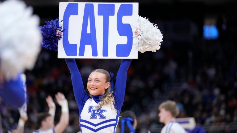 A Kentucky cheerleader holds a sign for the Wildcats. (Kayla Wolf/AP)