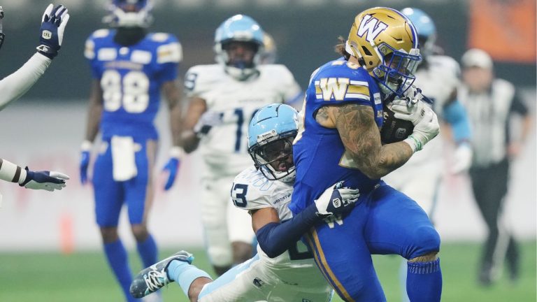 Winnipeg Blue Bombers' Brady Oliveira (right) is tackled by Toronto Argonauts' Benjie Franklin (23) during second half CFL football action at the 111th Grey Cup in Vancouver on Sunday, November 17, 2024. (Nathan Denette/CP)