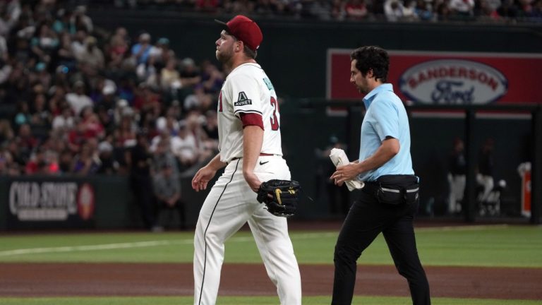 Arizona Diamondbacks pitcher Corbin Burnes, left, leaves a baseball game against the Washington Nationals in the fifth inning Sunday, June 1, 2025, in Phoenix. (Rick Scuteri/AP)