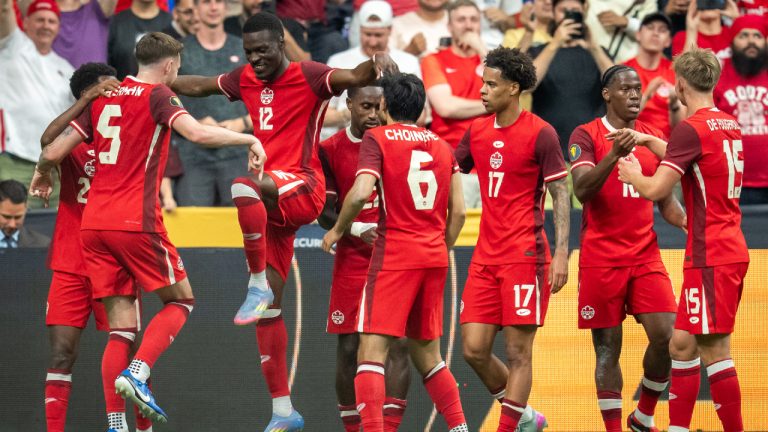 Canada's Tani Oluwaseyi (12) celebrates his goal against Honduras, with his teammates during the first half of a CONCACAF Gold Cup soccer match in Vancouver, on Tuesday, June 17, 2025. (Ethan Cairns/CP)