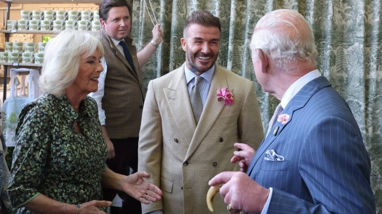 Britain's King Charles III and Queen Camilla speak with David Beckham at the Chelsea Flower Show in London, Monday May 19, 2025. (Toby Melville/Pool via AP)