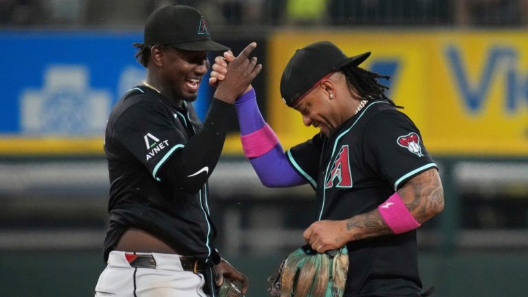 Arizona Diamondbacks shortstop Geraldo Perdomo, left, celebrates with second baseman Ketel Marte, right, after they defeated the Chicago White Sox in a baseball game in Chicago, Monday, June 23, 2025. (Nam Y. Huh/AP)