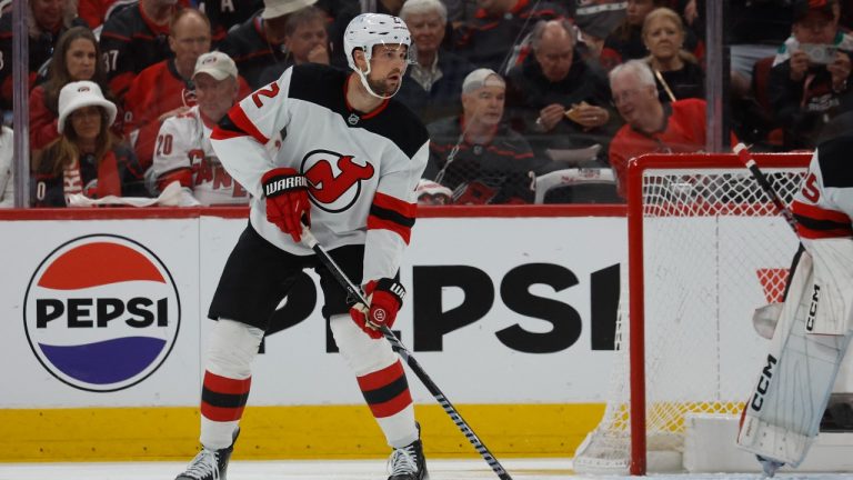 New Jersey Devils' Brian Dumoulin (2) controls the puck against the Carolina Hurricanes during the first period of Game 5 of an NHL hockey Stanley Cup first-round playoff series in Raleigh, N.C., Tuesday, April 29, 2025. (Karl DeBlaker/AP Photo)