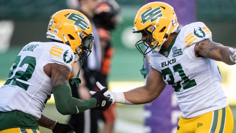 Edmonton Elks' Javon Leake (22) and Justin Rankin (31) celebrate against the B.C. Lions during first half CFL pre-season action in Edmonton, on Friday May 30, 2025. (Jason Franson/CP)