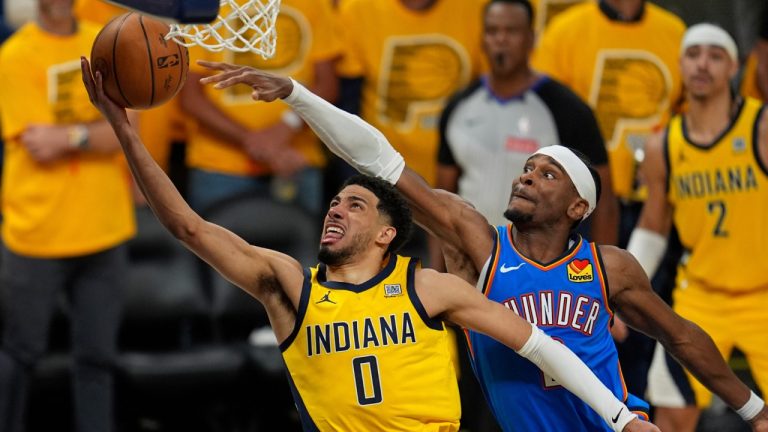 Indiana Pacers guard Tyrese Haliburton (0) shoots under Oklahoma City Thunder guard Shai Gilgeous-Alexander during the second half of Game 4 of the NBA Finals basketball series, Friday, June 13, 2025, in Indianapolis. (Abbie Parr/AP)