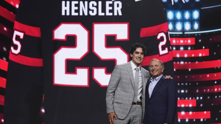 Logan Hensler, left, stands with NHL commissioner Gary Bettman after being drafted by the Ottawa Senators during the NHL hockey draft. (Damian Dovarganes/AP)