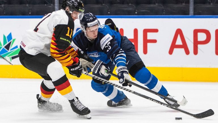 Finland's Roby Jarventie (13) and Germany's Korbinian Geibel (11) battle for the puck during first period IIHF World Junior Hockey Championship quarterfinal action in Edmonton on Wednesday August 17, 2022. (Jason Franson/CP)