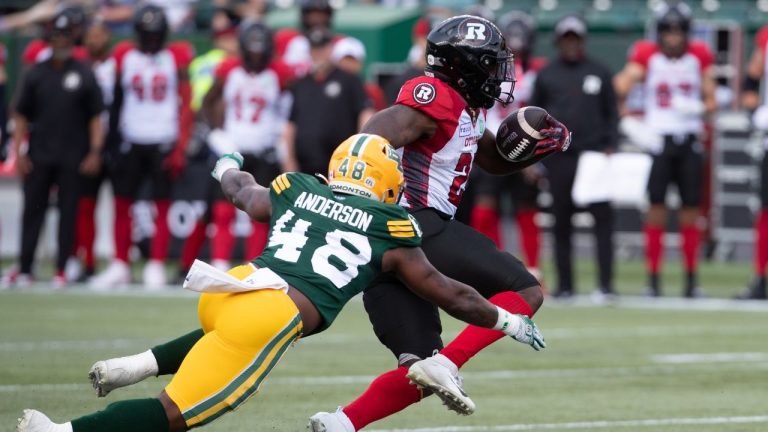 Ottawa Redblacks' Ryquell Armstead (25) is tackled by Edmonton Elks' Nick Anderson (48) during first half CFL action in Edmonton, Alta., on Sunday July 14, 2024. (Jason Franson/CP)