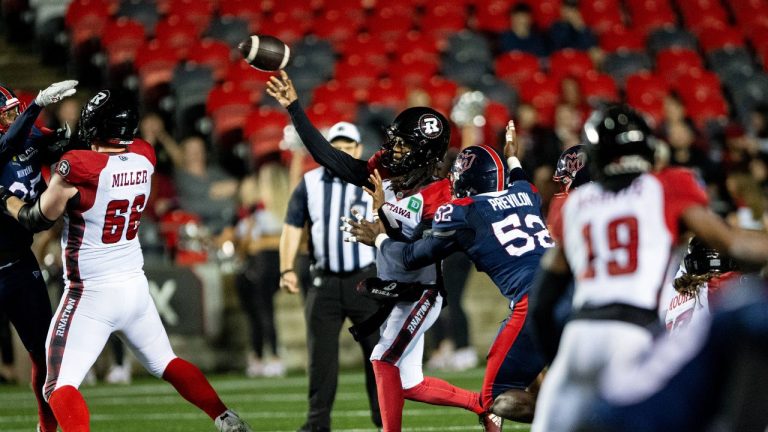 Ottawa Redblacks defensive back Shakur Brown (7) works under pressure by Montreal Alouettes' Willington Previlon (52) during second half CFL pre-season football action in Ottawa, on Friday, May 30, 2025. (Spencer Colby/CP)