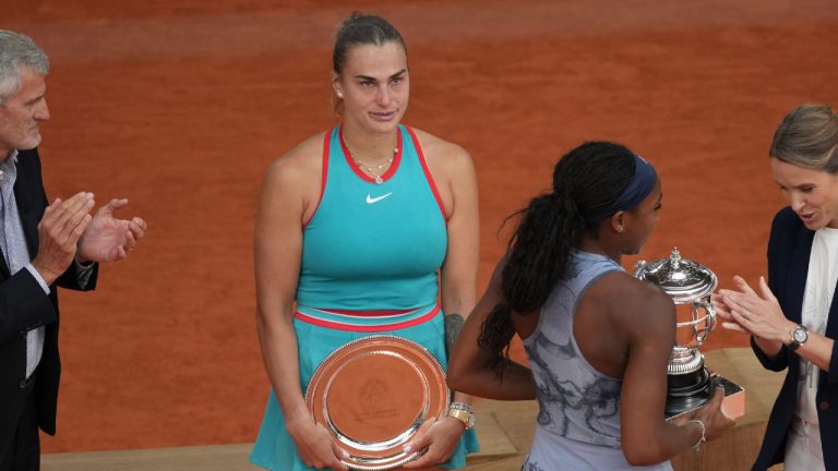 Second placed Aryna Sabalenka of Belarus, centre left, reacts as winner Coco Gauff of the U.S. receives her trophy after their final match of the French Tennis Open at the Roland-Garros stadium in Paris, Saturday, June 7, 2025. (Christophe Ena/AP)