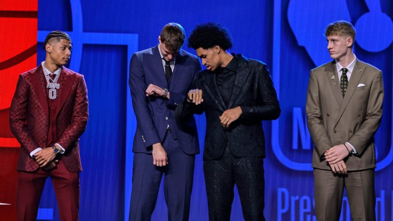 Cooper Flagg, second from left, and Dylan Harper, second from right, check their watches before the start of the first round of the NBA basketball draft, Wednesday, June 25, 2025, in New York. (Adam Hunger/AP)