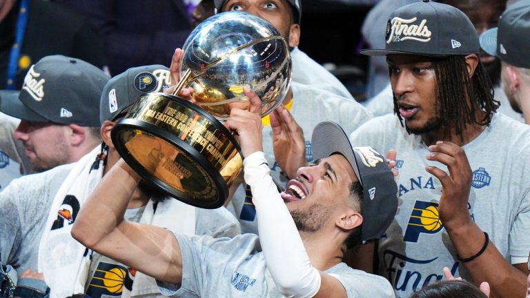 Indiana Pacers guard Tyrese Haliburton holds up the trophy after the Pacers won Game 6 of the Eastern Conference finals of the NBA basketball playoffs against the New York Knicks in Indianapolis, Saturday, May 31, 2025. (AJ Mast/AP)