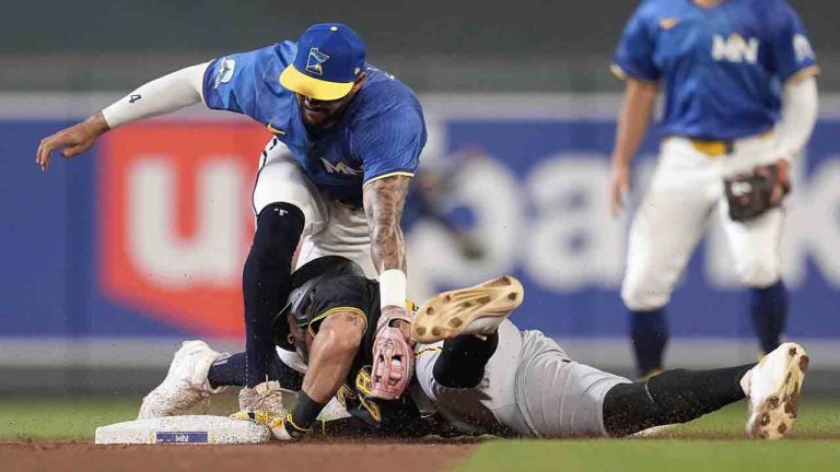Pittsburgh Pirates' Tommy Pham, bottomleft, is tagged out by Minnesota Twins shortstop Carlos Correa, top left, during the seventh inning of a baseball game Friday, July 11, 2025, in Minneapolis. Correa was injured on the play. (Abbie Parr/AP)