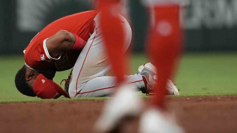 Los Angeles Angels second baseman Christian Moore (4) is helped after being injured fielding a ball hit by Atlanta Braves' Ozzie Albies in the sixth inning of a baseball game, Wednesday, July 2, 2025, in Atlanta. (Mike Stewart/AP)
