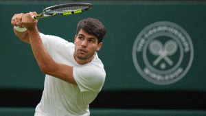 Spain's Carlos Alcaraz returns to Russia's Andrey Rublev during a fourth round men's singles match at the Wimbledon Tennis Championships in London, Sunday, July 6, 2025. (AP/Alastair Grant)