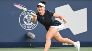Bianca Andreescu, of Canada, lunges for the ball during her first round match against Barbora Krejcikova, of the Czech Republic, at the National Bank Open tennis tournament in Montreal, Sunday, July 27, 2025. (THE CANADIAN PRESS/Graham Hughes)