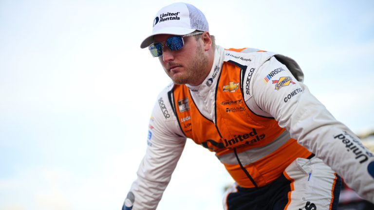 Austin Hill interacts with spectators while walking down a runway during driver introductions before a NASCAR Cup Series auto race at Daytona International Speedway, Saturday, Aug. 24, 2024, in Daytona Beach, Fla. (Phelan M. Ebenhack/AP)