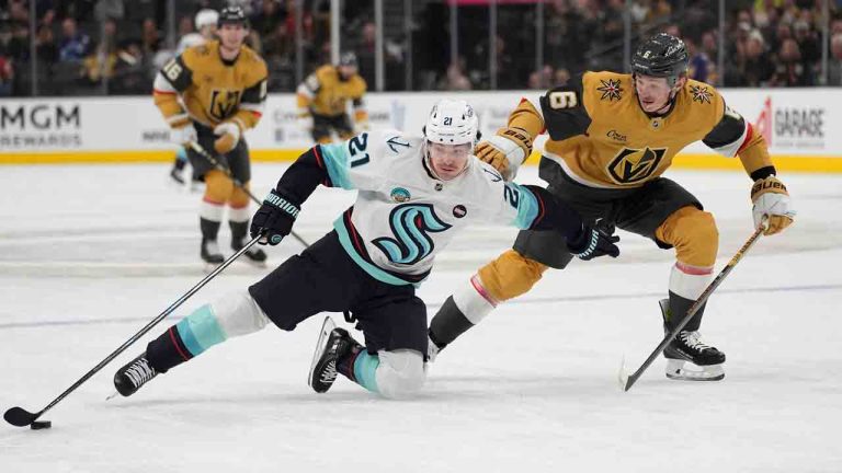 Seattle Kraken centre Michael Eyssimont (21) attempts to skate around Vegas Golden Knights defenseman Kaedan Korczak (6) during the first period of an NHL hockey game Thursday, April 10, 2025, in Las Vegas. (John Locher/AP)