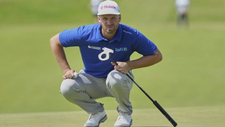 Wyndham Clark of the United States looks at the lie of his putt on the 1st green during the final round of the British Open golf championship at the Royal Portrush Golf Club, Northern Ireland, Sunday, July 20, 2025. (AP/Jon Super)
