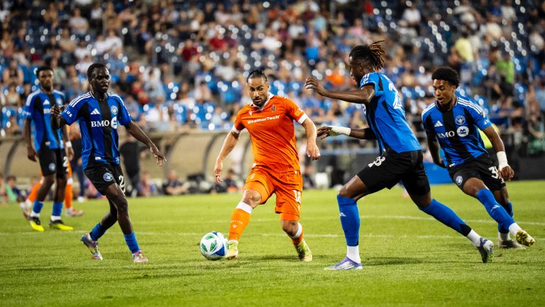 Forge FC's Molham Babouli (18) defended by CF Montreal's Victor Loturi (22), Jules-Anthony Vilsaint (28) and Owen Graham-Roache (35) during second half Canadian Championship quarter-final soccer action, in Montreal, on Wednesday, July 9, 2025. (Christopher Katsarov/CP)