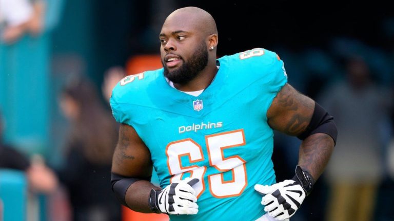 Miami Dolphins offensive lineman Robert Jones (65) runs onto the field during player introductions before an NFL football game against the San Francisco 49ers, Sunday, Dec. 22, 2024, in Miami Gardens, Fla. (Doug Murray/AP)