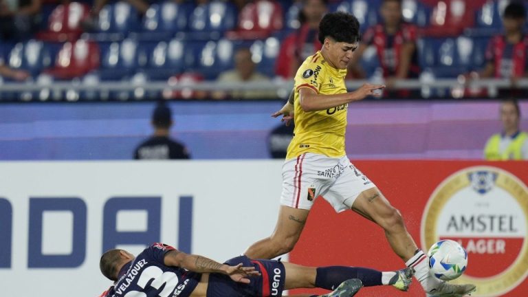 Kenji Cabrera of Peru's Melgar, top, and Victor Velazquez of Paraguay's Cerro Porteno battle for the ball during a Copa Libertadores soccer match at Nueva Olla stadium in Asuncion, Paraguay, Wednesday, March 12, 2025. (Jorge Saenz/AP)