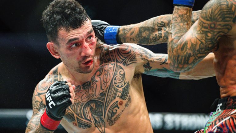 Max Holloway in a UFC lightweight fight. (Ella Hall/AP)