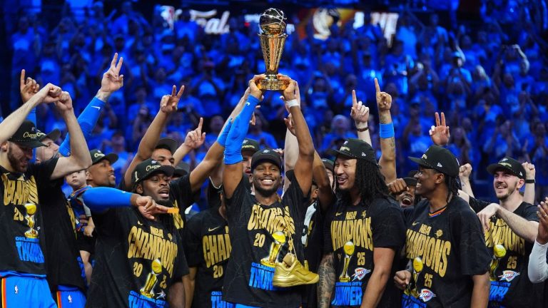 Oklahoma City Thunder guard Shai Gilgeous-Alexander holds up the MVP trophy as he celebrates with his team after they won the NBA basketball championship with a Game 7 victory against the Indiana Pacers Sunday, June 22, 2025, in Oklahoma City. (Julio Cortez/AP)