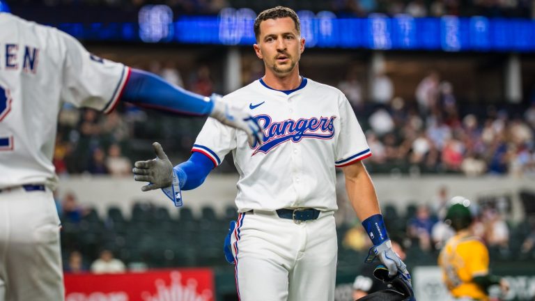 Texas Rangers' Nick Ahmed is congratulated after scoring a run during the eighth inning of a baseball game against the Athletics, Tuesday, April 29, 2025, in Arlington, Texas. (Jessica Tobias/AP)