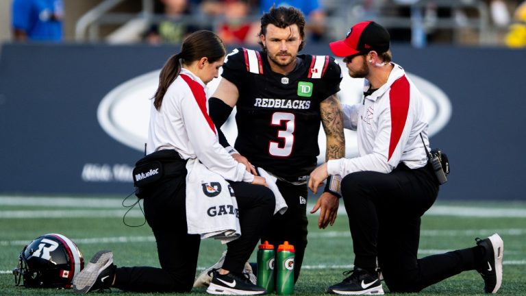 Ottawa Redblacks quarterback Dru Brown (3) is attended to by team medics following a sack during first half CFL action against the Hamilton Tiger-Cats in Ottawa on Sunday, July 20, 2025. (Spencer Colby/CP)