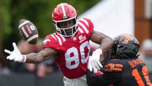 Calgary Stampeders' Damien Alford, left, reaches for the ball as B.C. Lions' Travian Blaylock defends during the second half of a pre-season CFL football game, in Langford, B.C., on Monday, May 19, 2025. (Darryl Dyck/CP)