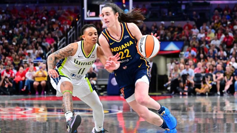 Indiana Fever's Caitlin Clark (22) goes to the basket against Dallas Wings' JJ Quinerly (11) during the second half of a WNBA basketball game, Sunday, July 13, 2025, in Indianapolis. (Doug McSchooler/AP)