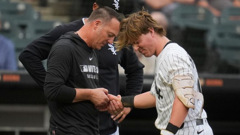 Chicago White Sox's Chase Meidroth (10) is examined after he was hit in the hand with a pitch from Philadelphia Phillies starting pitcher Taijuan Walker (99) during the fifth inning of a baseball game Wednesday, July 30, 2025, in Chicago. (Erin Hooley/AP)